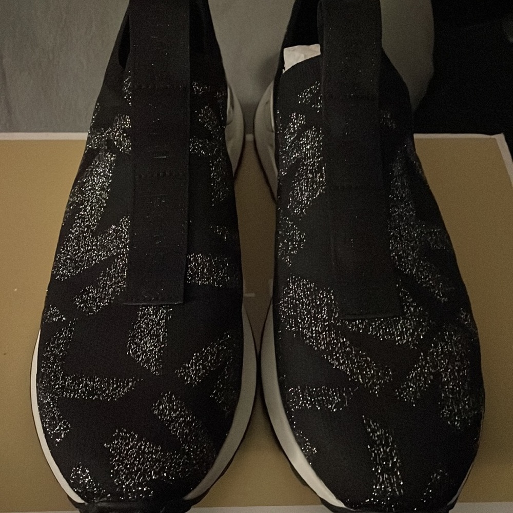 Michael Kors slip on tennis shoe, black with silver MK logo print, size 7 1/2